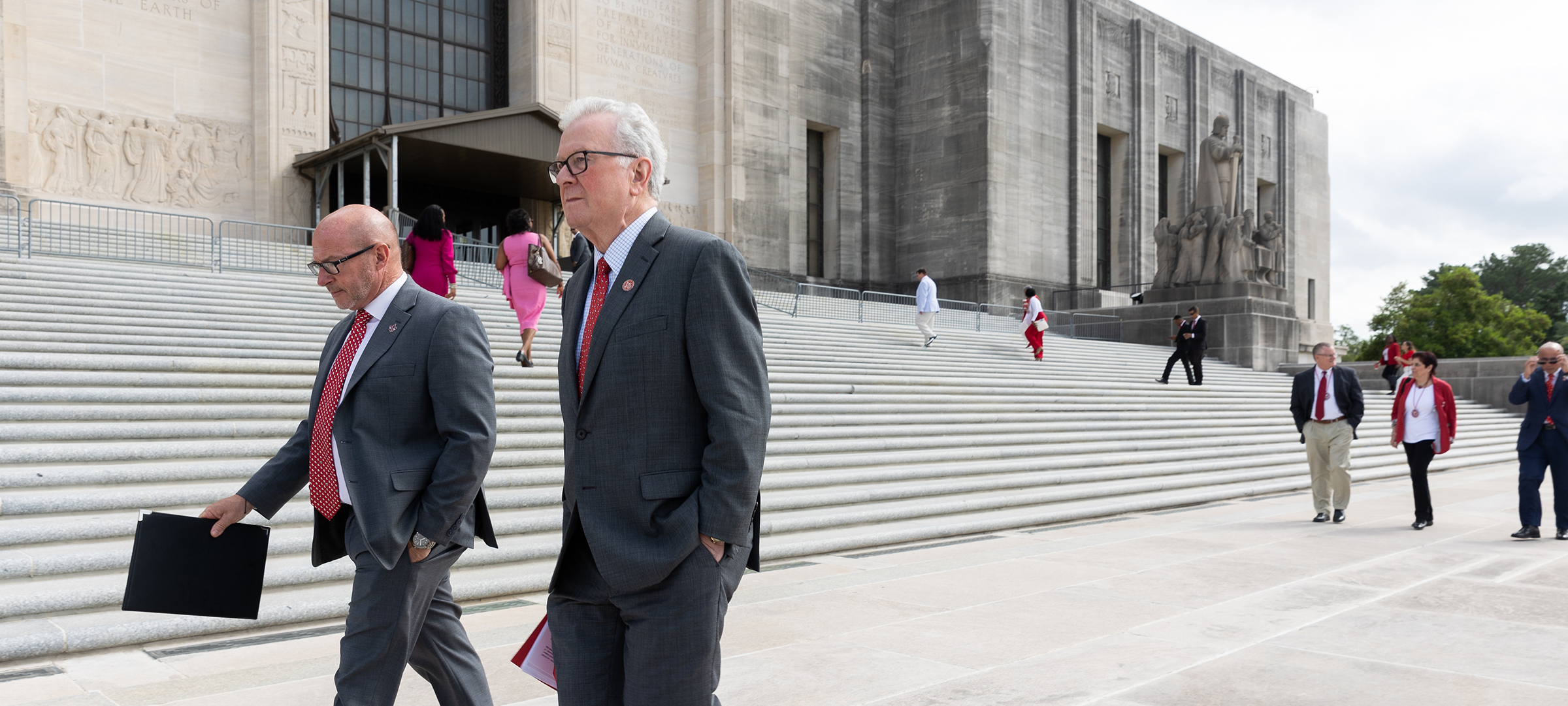 Dr. Hebert and Dr. Savoie walk on the steps of the state capitol
