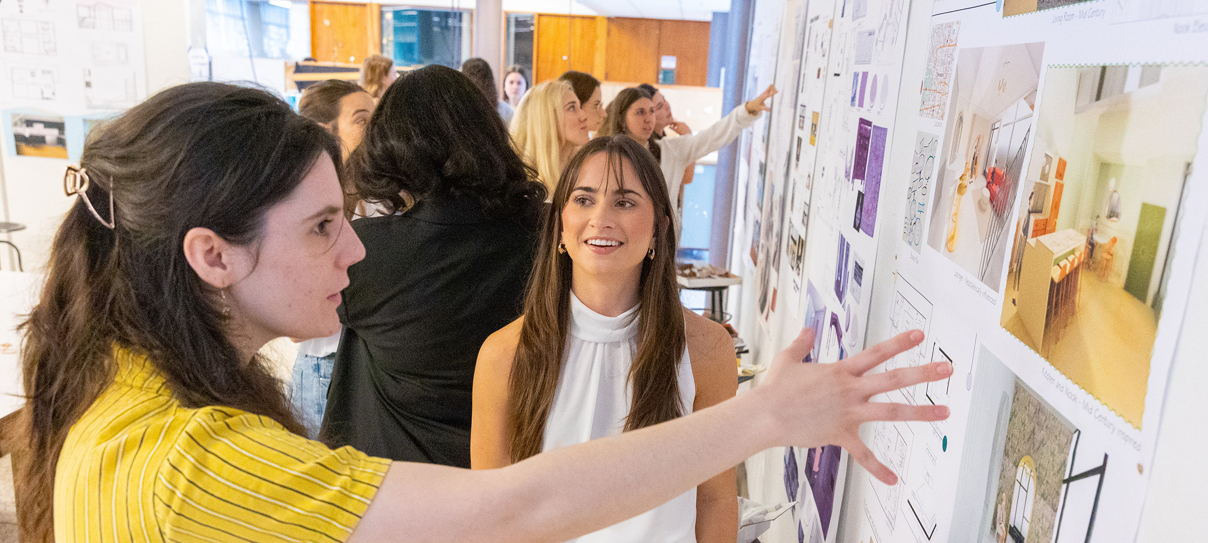 UL Lafayette interior design students assessing a wall of design options.