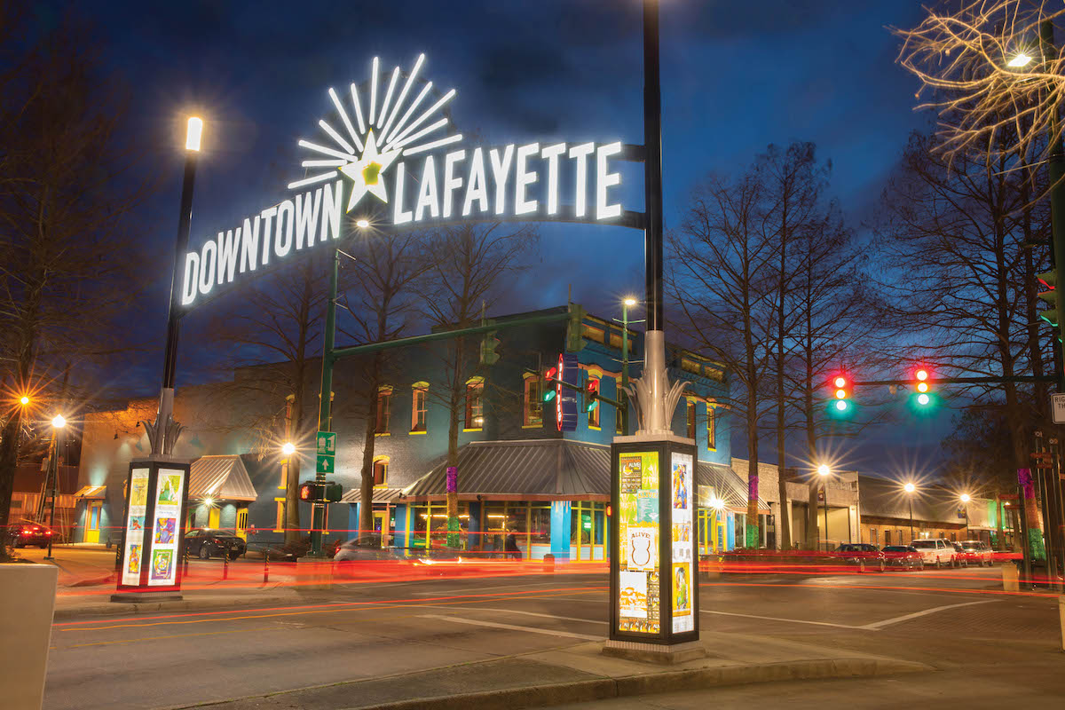 The Downtown Lafayette sign on Jefferson Street lit up at night
