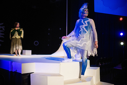 UL student on stage in blue wig