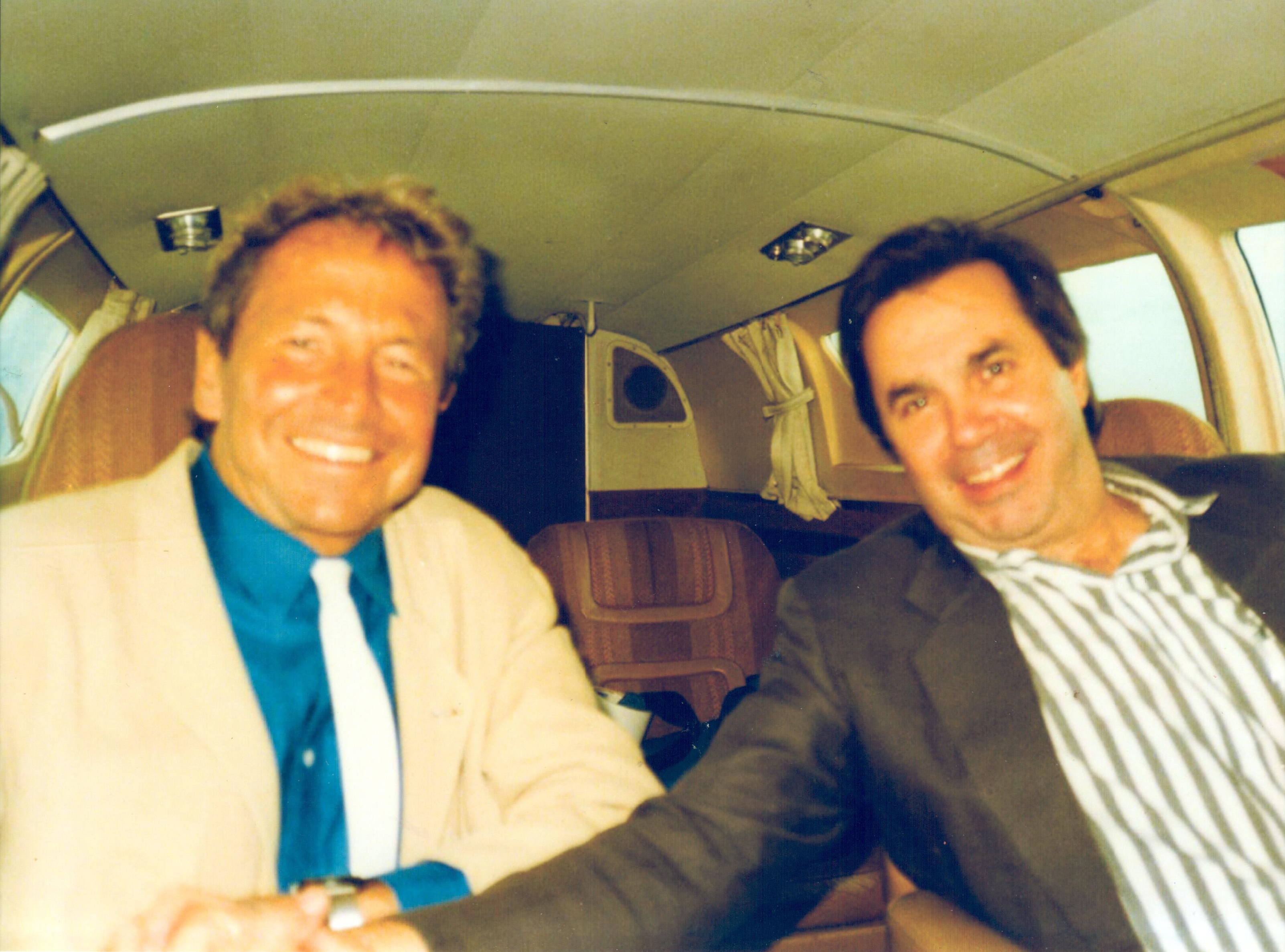Rauschenberg (left) and Dickie Landry on a private jet for the ROCI CUBA exhibition presented in Havana in 1988 as part of the Rauschenberg Overseas Culture Interchange project.