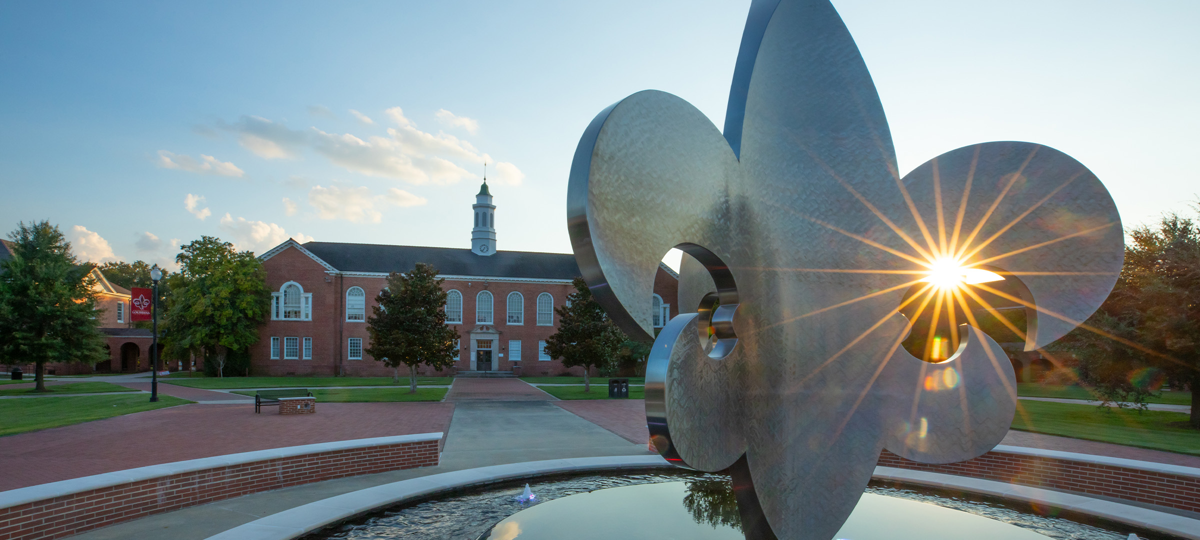 UL Lafayette Stephens hall behind the fleur-de-lis fountain in the Quad.