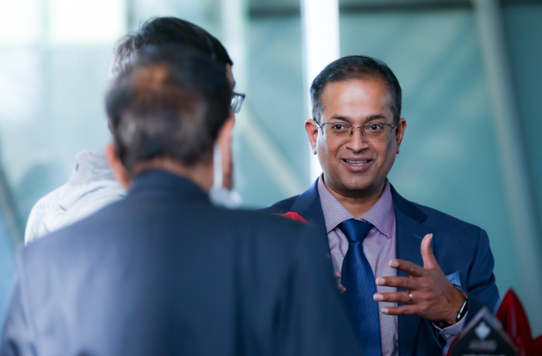 Dr. Ramesh Kolluru speaking to a group of people