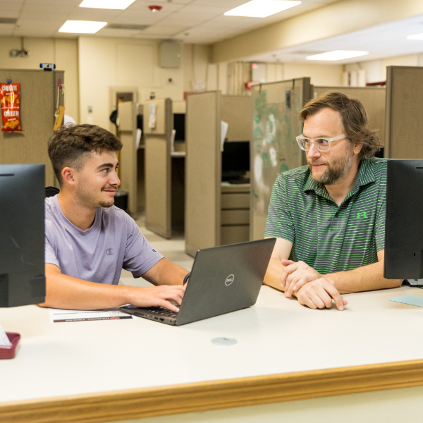 UL Lafayette staff in front of a row of computers.