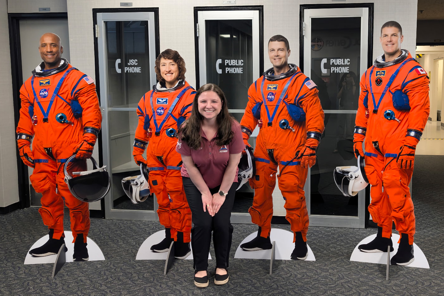 UL Lafayette grad with cutouts of Artemis astronauts