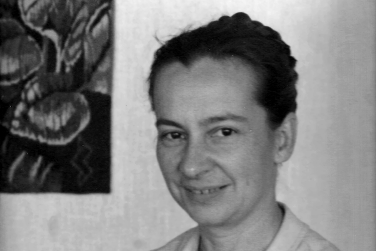 Black and white portrait of middle-aged woman with her hair pulled back in a bun.