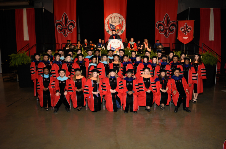 A group photo of faculty in their robes at the doctoral hooding ceremony