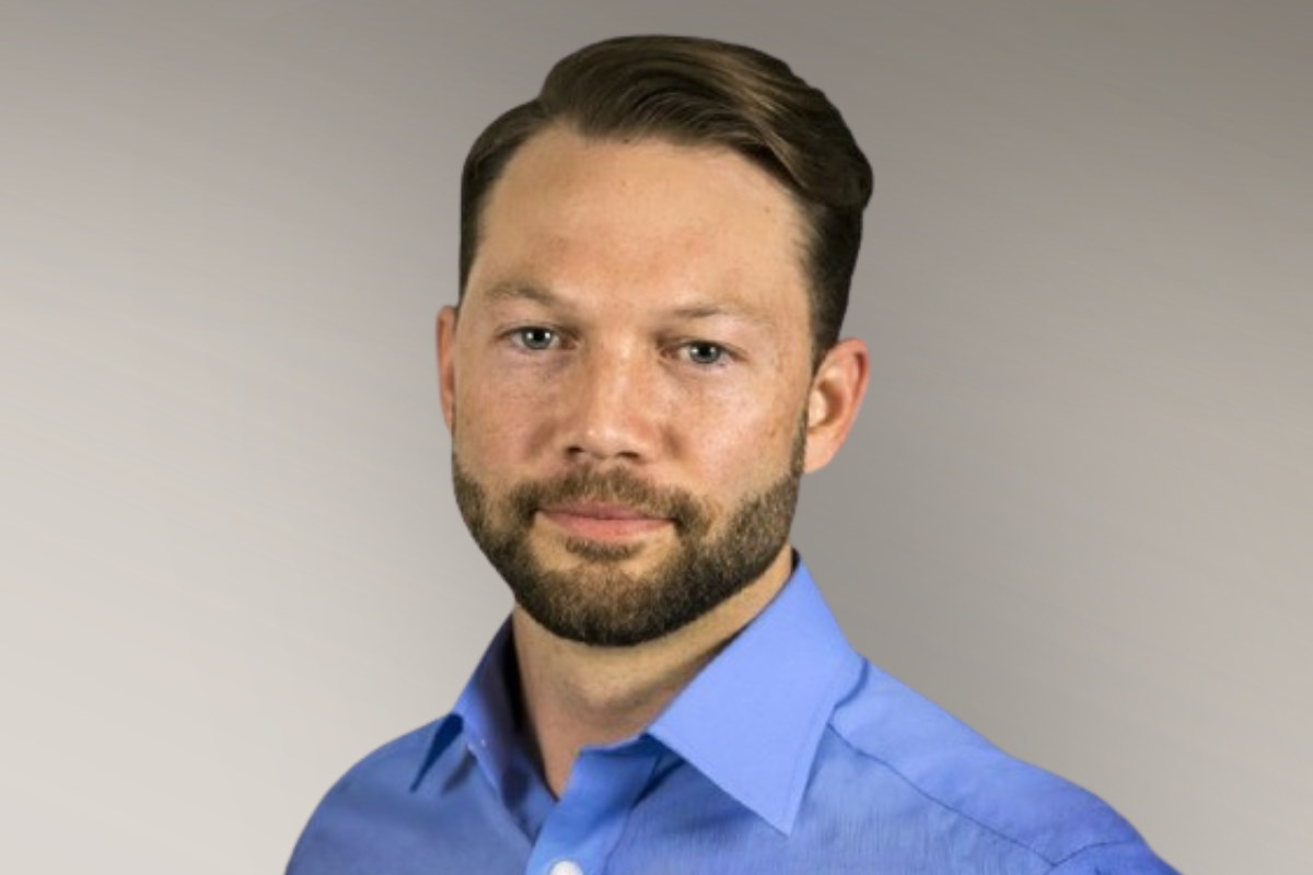 Online MS in Engineering Tech grad poses for headshot wearing a blue collared shirt.