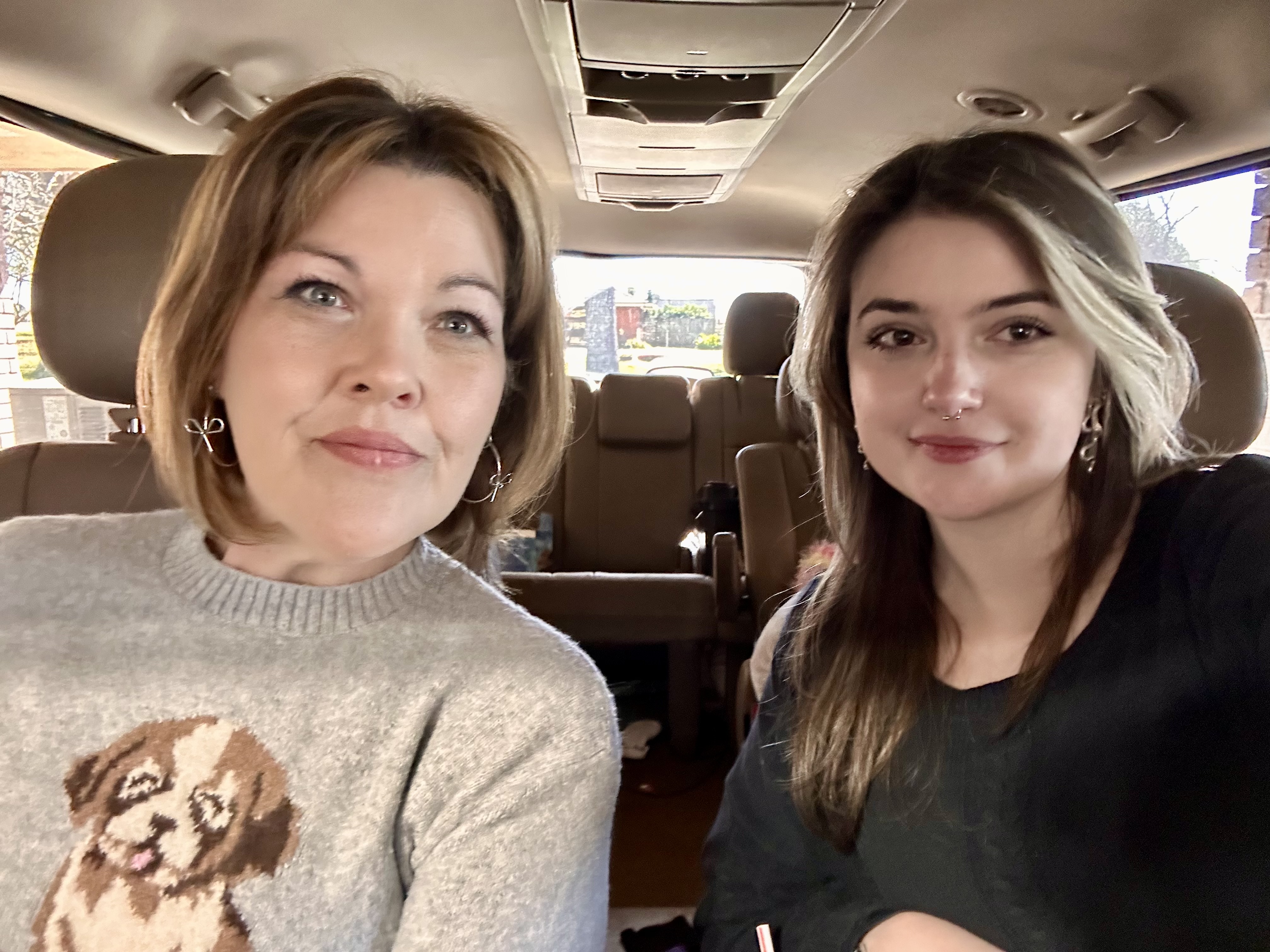 A selfie of a mother and daughter in a car