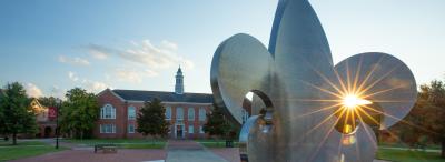 UL Lafayette Stephens hall behind the fleur-de-lis fountain in the Quad.