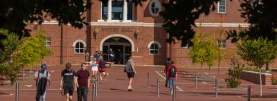 Students walking around in front of Moody Hall.