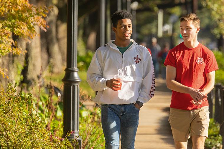 Two University of Louisiana at Lafayette students walking on the sidewalk