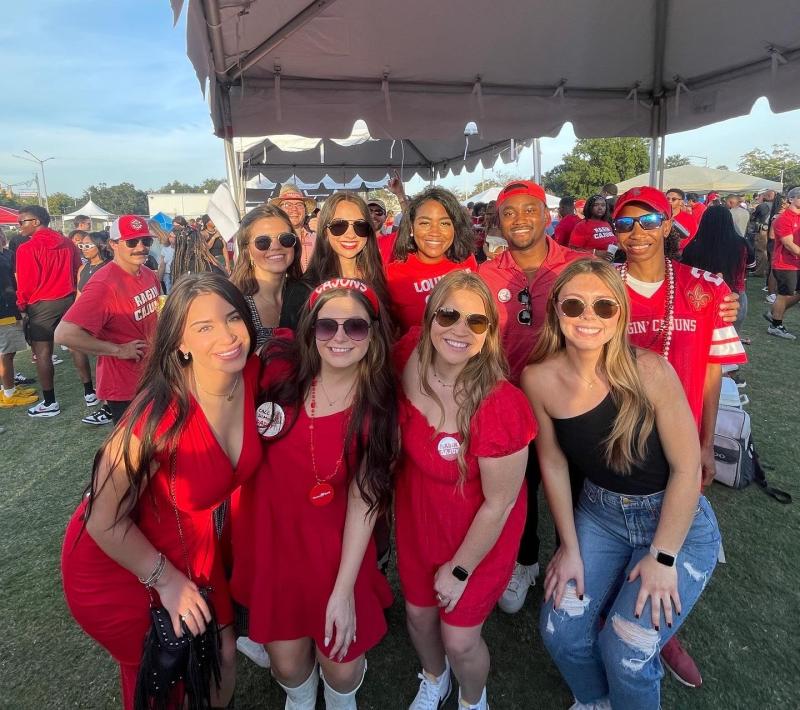 April Piper attends a homecoming tailgate with her friends in UL Lafayette's MBA Association.