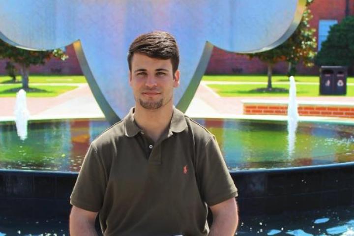 Logan Marks in front of Fleur De Lis fountain