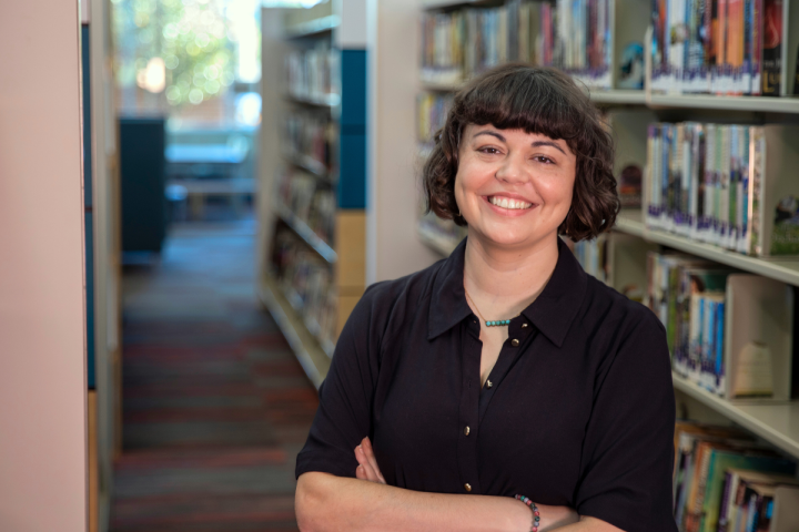 Ashley Mudd, graduate of UL Lafayette's B.A. in Sociology program, smiles with arms crossed.