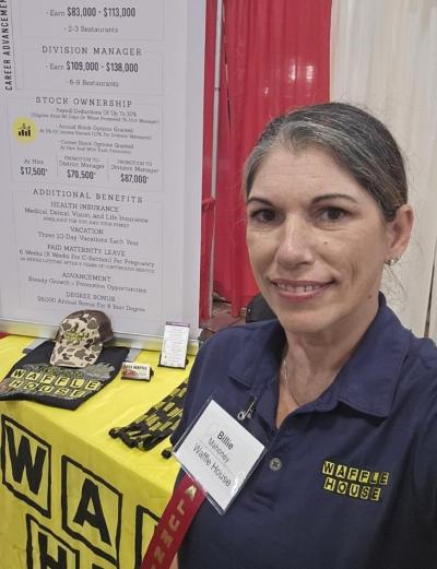 Online general studies graduate works a career fair as part of her role as manager of a local Waffle House