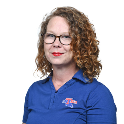 Whitney Sivils-Sawyer smiles for headshot wearing a blue LA Tech polo.