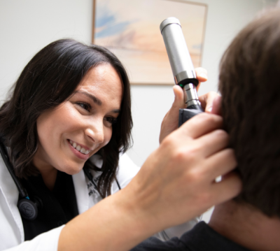 Nurse performing an ear exam; graduates of UL Lafayette’s online RN-BSN program and MSN program apply advanced skills in patient care.