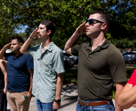 Online M.S. in Engineering Management graduate salutes as part of the Student Veterans' Organization flag raising event.