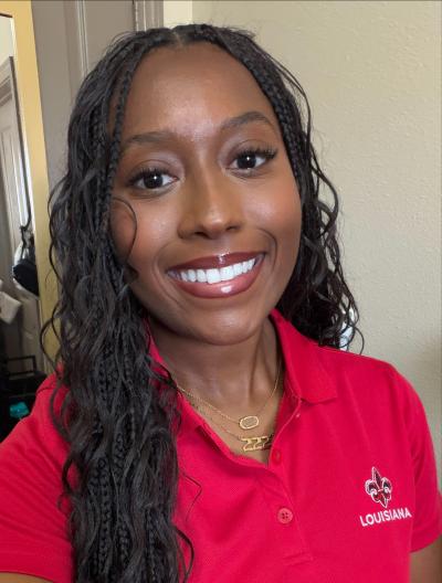 Smiling headshot of Delaney B in a red UL polo