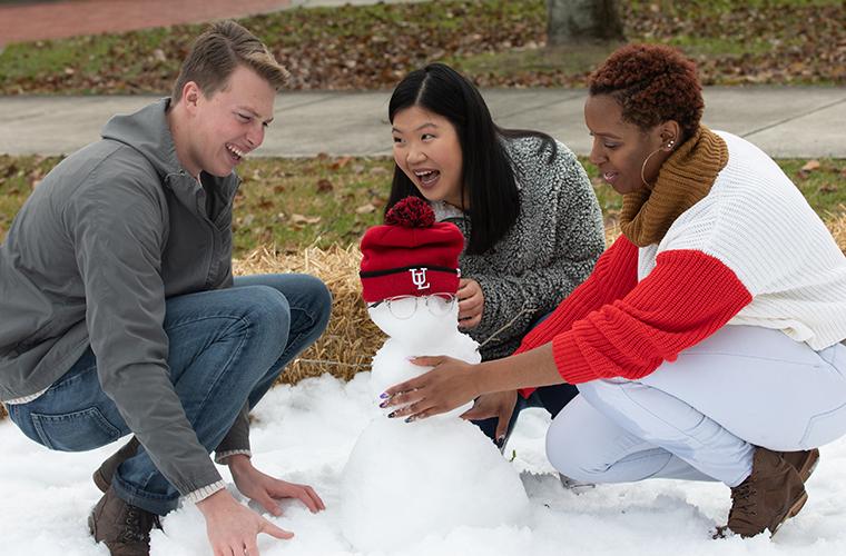 students building snow man at snow day