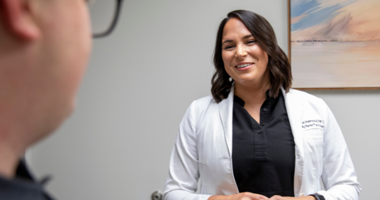 Nurse speaks with patient; UL Lafayette’s online RN-BSN degree program brings expertise to patient care.