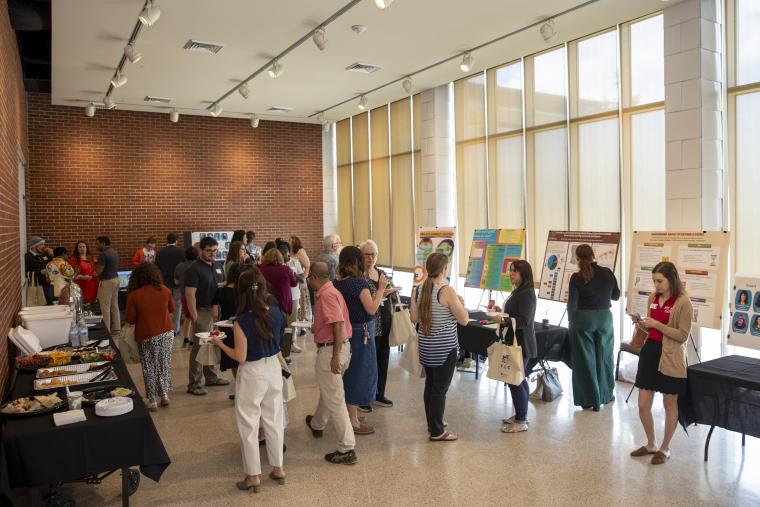 UL Lafayette faculty and staff are pictured in discussion and viewing poster presentations during the 2025 FLC Showcase.