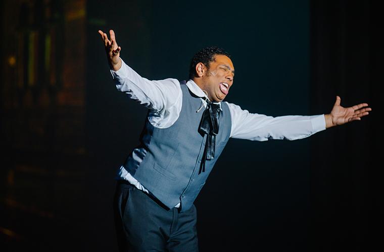 UL Lafayette theatre student sings with arms spread out to the audience