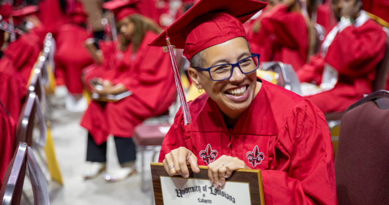 Graduate of the online RN to BSN program smiles after securing her bachelor's degree from UL Lafayette.