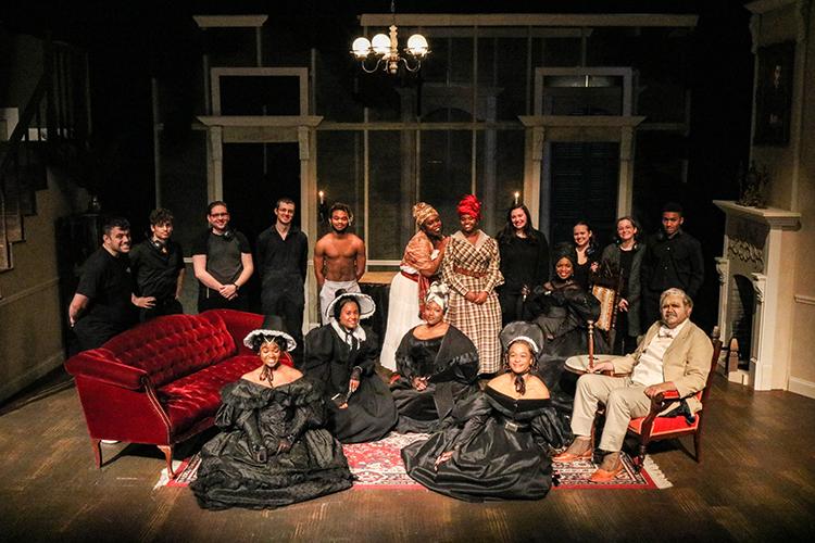 UL Lafayette students pose onstage as a full cast in period costume