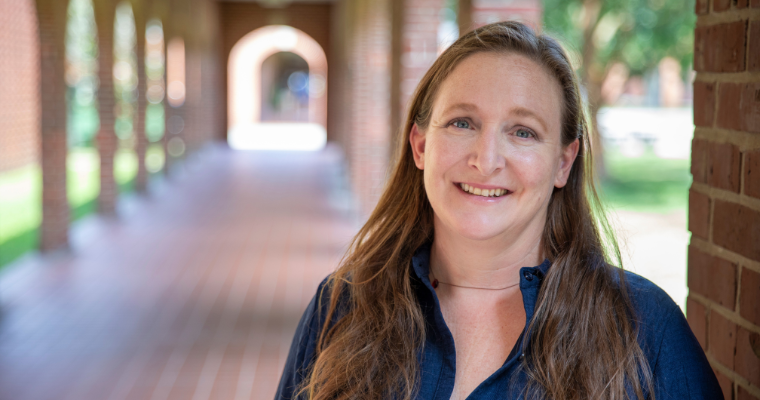A portrait of Dr. Natalie Keefer, associate professor and M.Ed. graduate coordinator for UL Lafayette, standing along the Walk of Honor on campus.