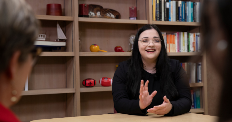 UL Lafayette online student collaborates with faculty and staff in the library. 