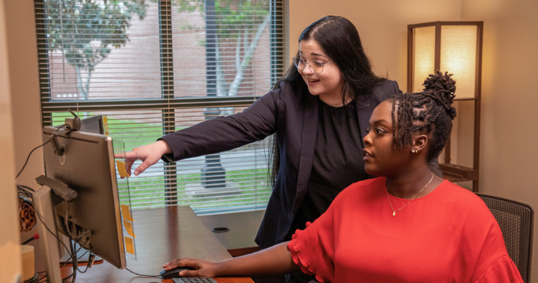 UL Lafayette graduate puts their psychology degree to work while collaborating with a coworker. 