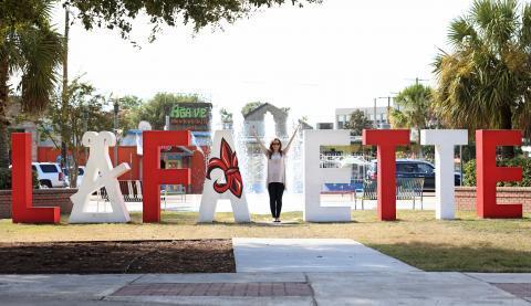 Large Lafayette sign with individual letters where the Y in the middle is only made when a person stands in it and makes the Y