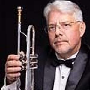 Portrait photograph of Paul Morton holding an instrument