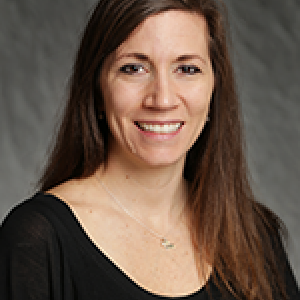 Portrait photo of Nicole Bruchez smiling and wearing a black blouse with a necklace.