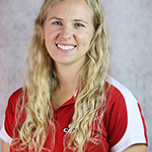 Portrait photo of Ashley Guidroz smiling wearing a red and white UL Lafayette polo shirt.