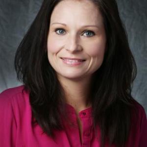 Portrait photo of Becky Dubois wearing a salmon colored suit