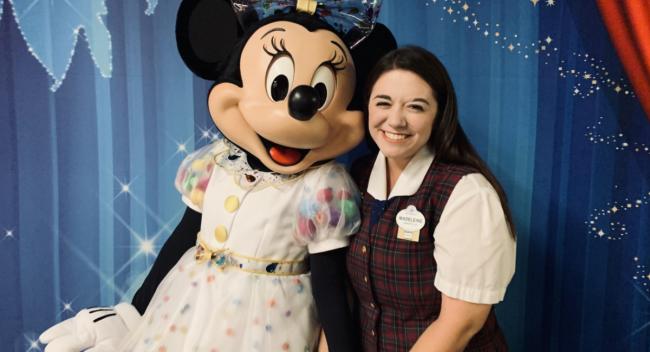 University of Louisiana at Lafayette alum Madeleine Comeaux stands with Disney's Minnie Mouse.
