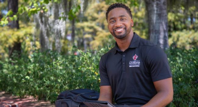 Ryan Owens is pictured outdoors near UL Lafayette's Cypress Lake. Owens earned his MBA online through UL Lafayette.