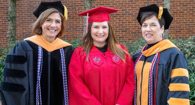 At Commencement, Brandy Sizemore, the 3000th graduate of the RN to BSN program, poses for a photo with Helen Fox-McCloy, Instructor in the program, and Lisa Broussard, Interim Dean and Professor in the College of Nursing & Health Sciences.