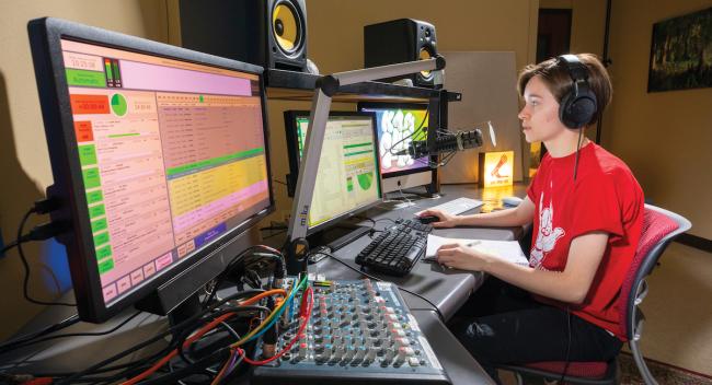 Kaley Mestayer sits in KampusFM's main control room.