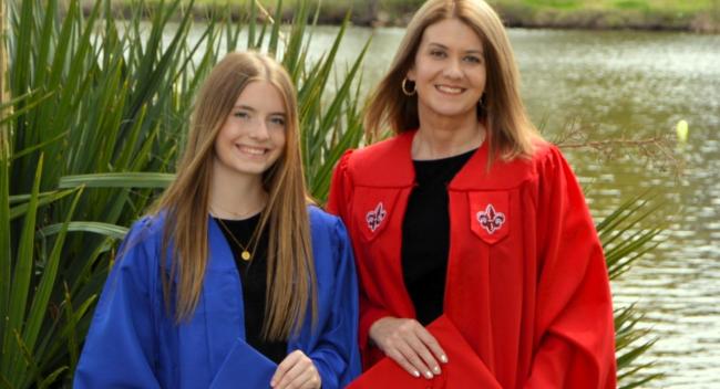 Karen Williams, HSA online graduate, poses with daughter in their caps and gowns.