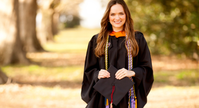 Audrey Reeves is pictured outdoors in graduation regalia. Reeves earned her MSN degree online through UL Lafayette.