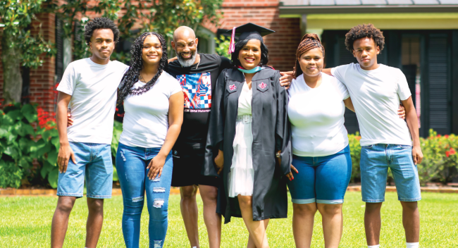 UL Lafayette M.Ed. graduate smiles for photo with her husband and four kids