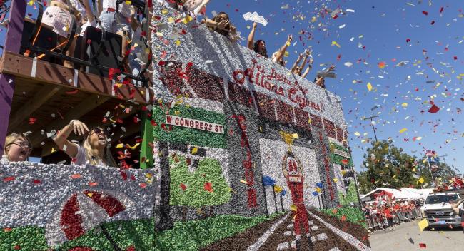 A float is covered in confetti as it rolls through the streets during the Homecoming Day Parade.