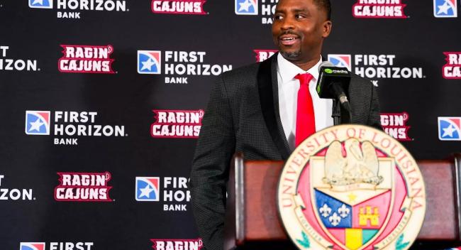 Men's basketball coach Quannas White speaks at a press conference.