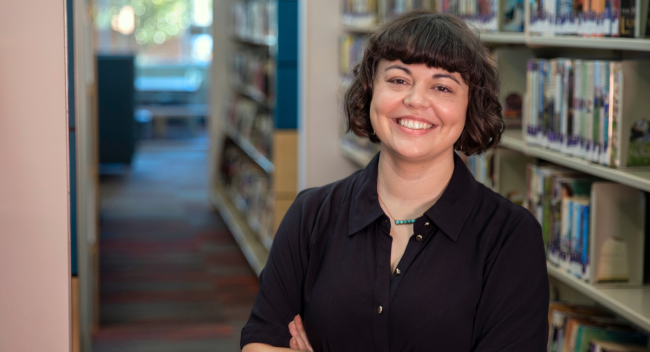 Ashley Mudd, graduate of UL Lafayette's B.A. in Sociology program, smiles with arms crossed.