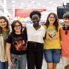 A group of people gathered around each other posing for the camera