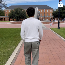 A Man walking in the quad